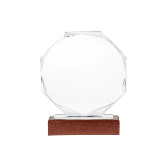 Personalized octagon crystal award with faceted edges on a wood base